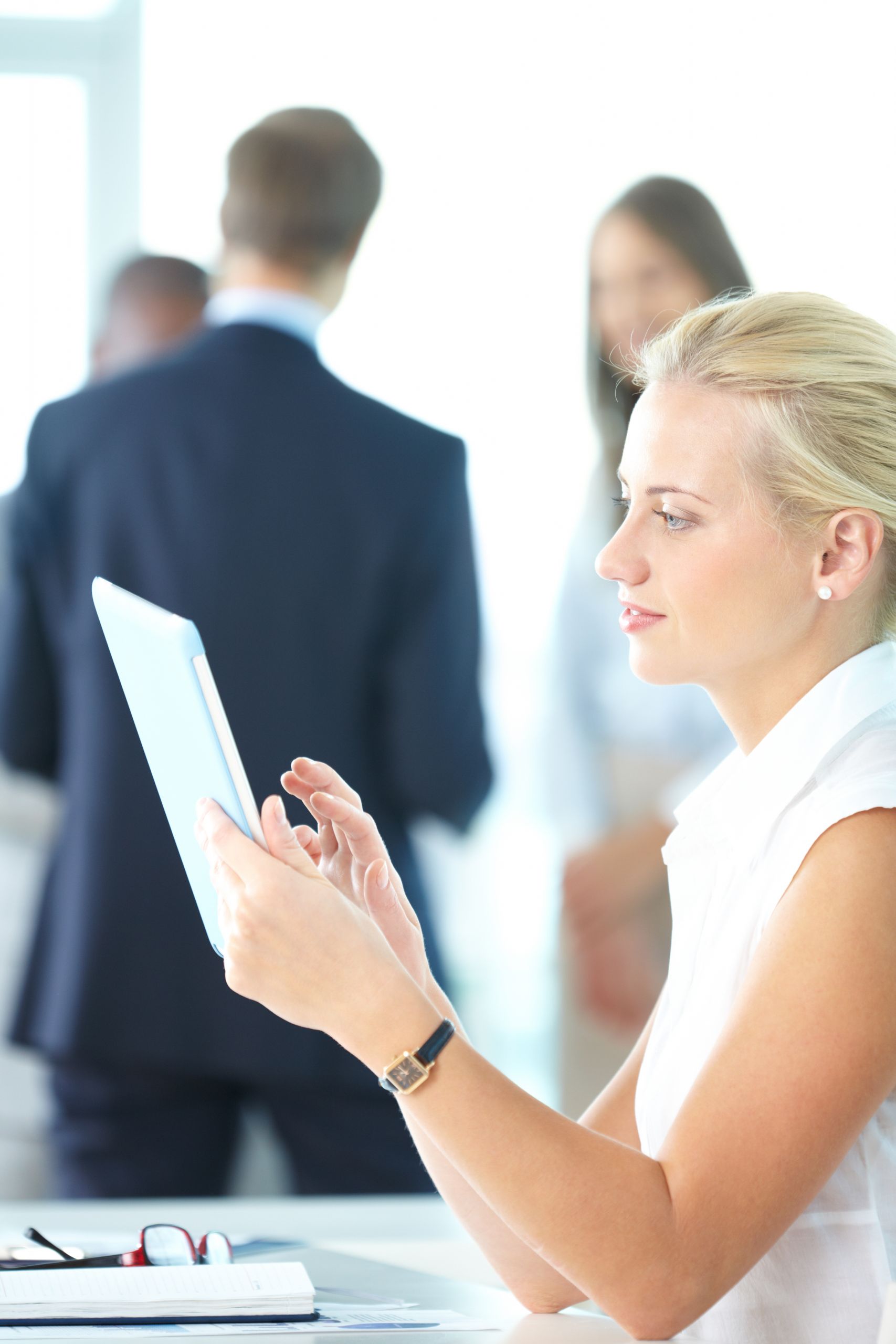 Portrait of pretty businesswoman uisng touchpad in working environment